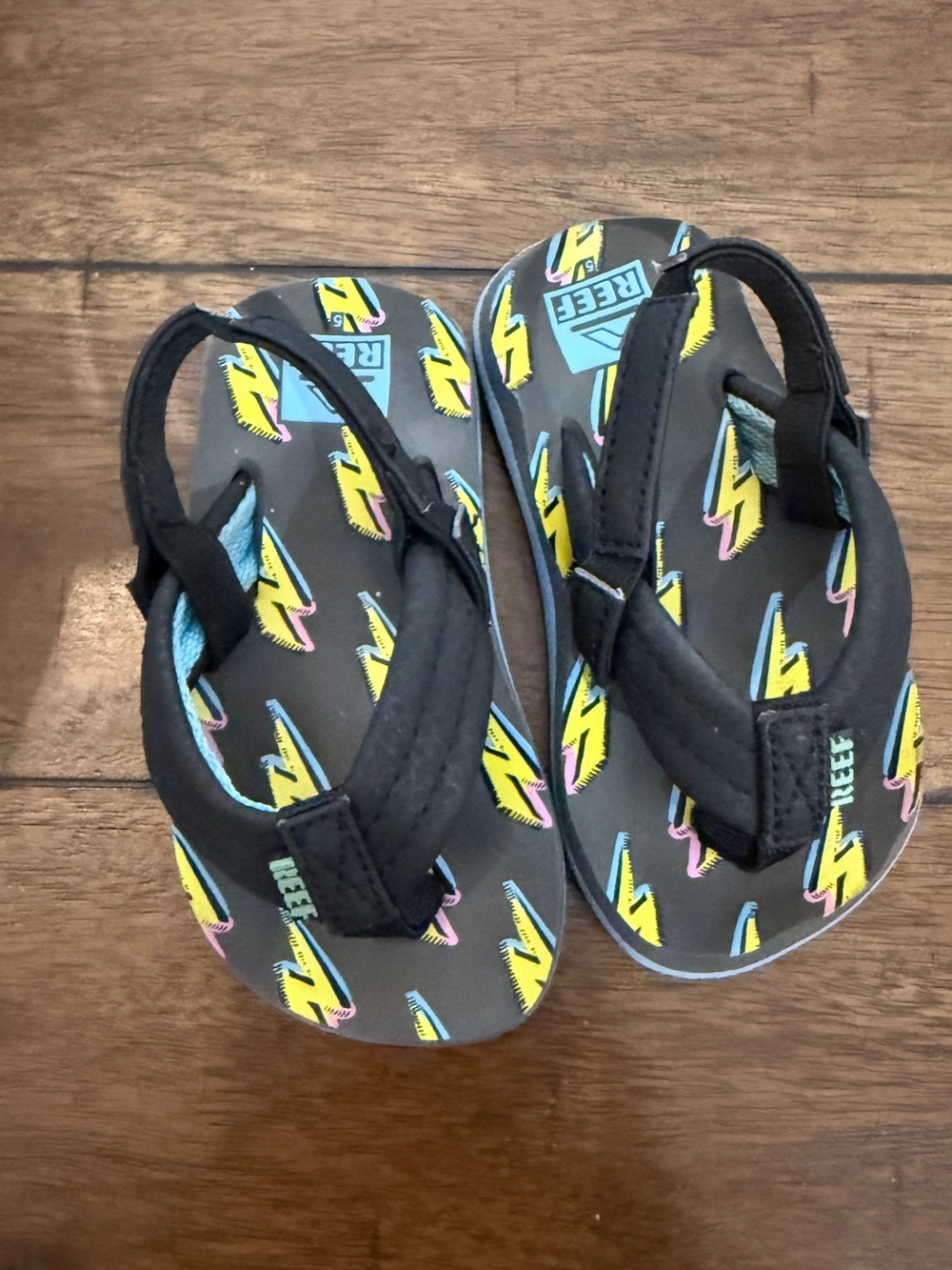 Reef Kids Black Flip Flops with Yellow Lightning Pattern